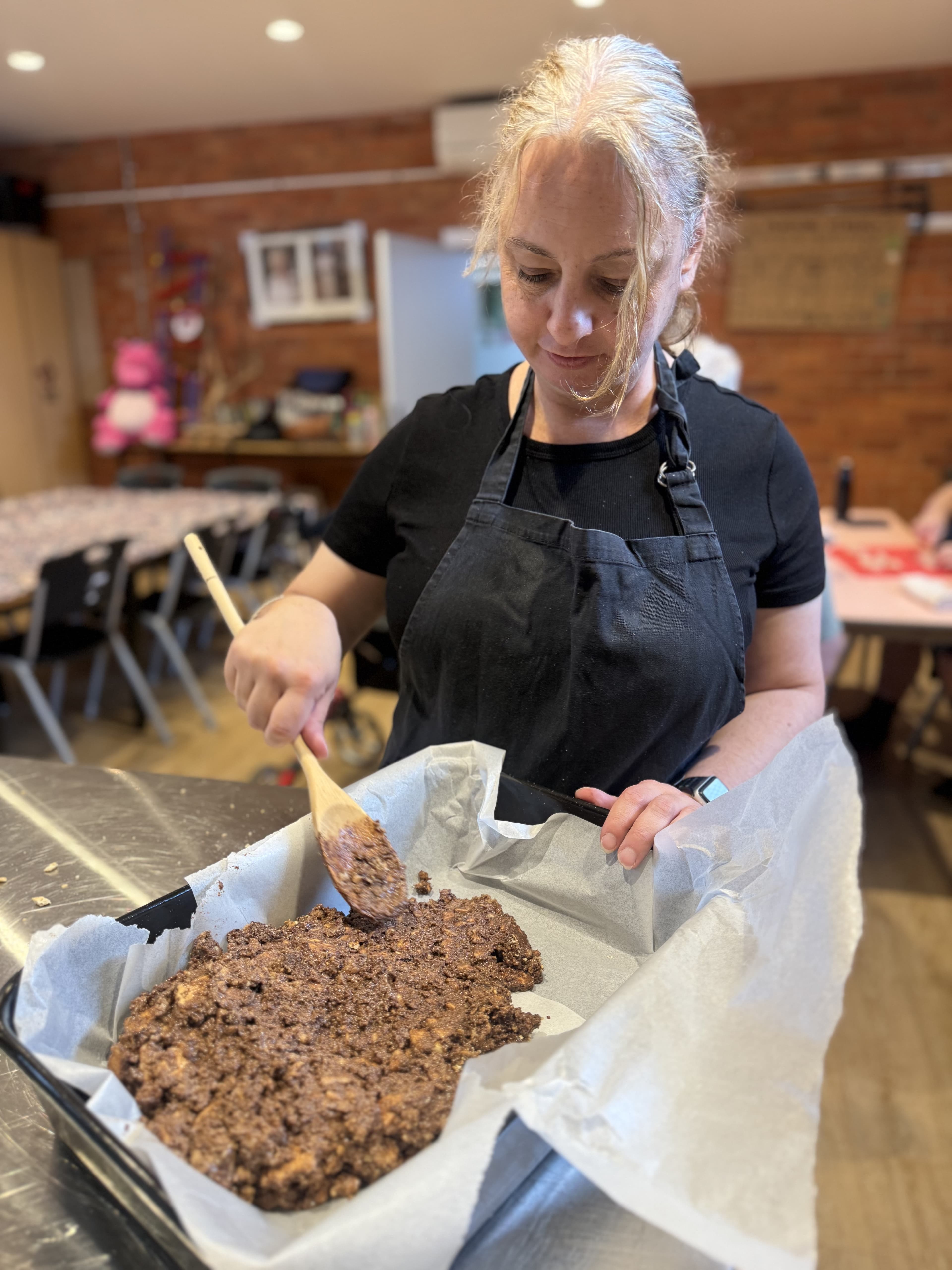 Mid-week at the Lyft Community Kitchen — pressing a baking tray.